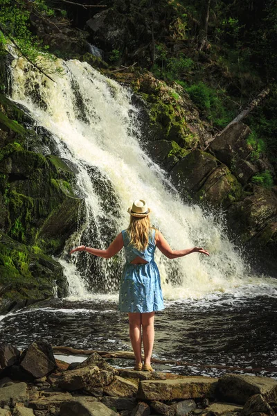 帽子の女性は滝の近くで瞑想します リラックスと自由の感覚 — ストック写真