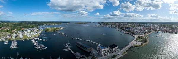 Vstervik: A breathtaking aerial view of the Swedish archipelago, city, and coastline, revealing a harbor, islands, and verdant land.