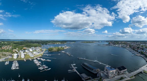 Vstervik: A breathtaking aerial view of the Swedish archipelago, city, and coastline, revealing a harbor, islands, and verdant land.