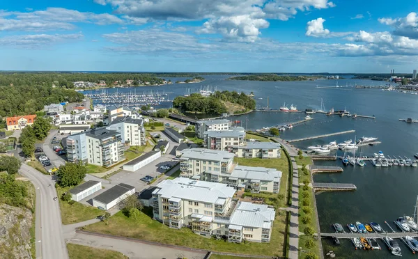 Aerial panorama view of multi story real estate apartment buildings in Vastervik used as vacation rentals in Sweden with boats