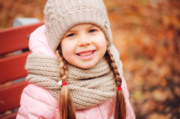 秋季特写照片快乐的小女孩享受在阳光公园漫步在温暖的针织帽子和围巾 — 图库照片