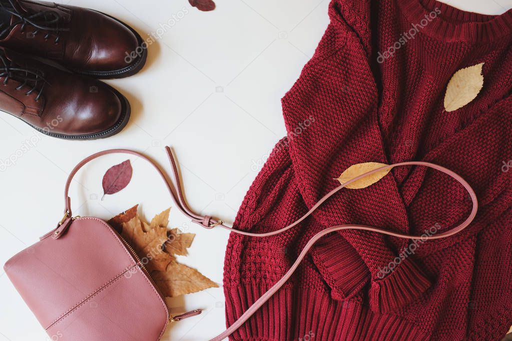 set of seasonal autumn fashion woman clothes, top view with copy space. Trendy shoes, sweater and handbag.