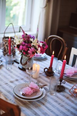 Romantik yaz yemek şirin ülkede evde. Çiçek ve mum mor tonlarda Festival tablo ayarı