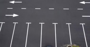 Drone flight over empty parking lot. One car on parking