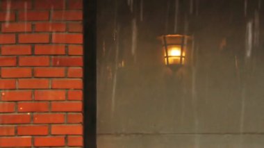 Eski bir ampulün 4K yansıması. Kahve dükkanının iç dekorasyonunda şiddetli yağmurla birlikte camdan sallanıyor. Yalnız insanları kavra ve dinlenmek için işten sonra rahatla.