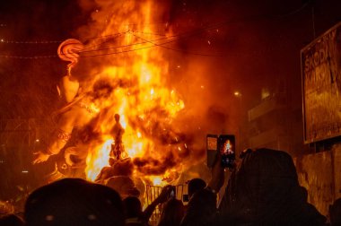 Valencia, Spain - March 19, 2019: End of the Valencian festivities of Fallas, Monument consumed in the fire in high flares. The Crem, a huge bonfire at the end of the Fallas festivities clipart