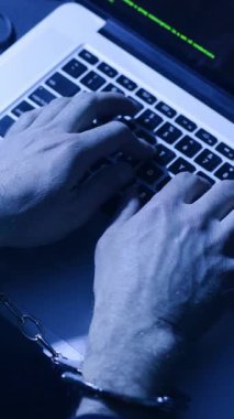 Videoda elleri kelepçeli bir şahsın dizüstü bilgisayarda yazı yazmaya çalışmasını gösteriyor. Gergin bir arkaplana karşı özgürlük arayışını simgeliyor.