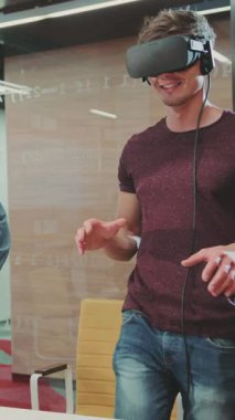 Kot gömlekli bir adam sanal gerçekliğe dalmadan önce duyusal keşifleri ima ederek klavye ve kulaklıkla etkileşim kurar.