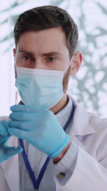 Pandemik koronavirüs. Tıbbi maske takan doktor yardımcısı grip aşısı sıvısı enjekte ediyor. Hasta bir hasta. Yaşlılar.