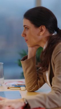 İletişim. Meslektaşlar. Esmer, beyaz bir kadın yönetici dizüstü bilgisayarını kullanarak iş yerinde en iyi arkadaşının konuşmasını dinliyor..