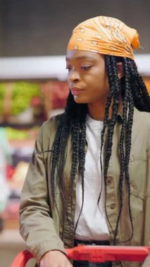 Düşünceli bir alışverişçi bugün yerel bir markette taze ve canlı ürünlere göz gezdiriyor.