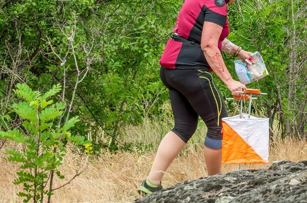 Orienteering. Check point Prism and composter for orienteering. The athlete marks the passage of the control point. Orienteering race