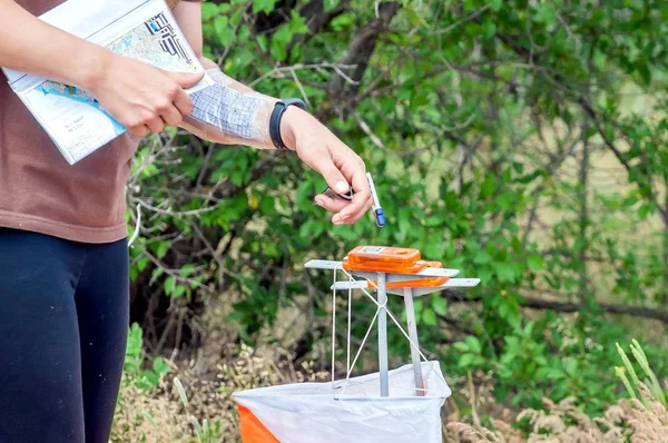 Orienteering. Check point Prism and composter for orienteering. The athlete marks the passage of the control point. Orienteering race