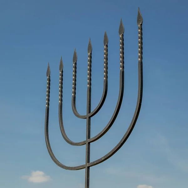 The menorah is a symbol of Judaism, the national-religious sign of Israel. Monument to the victims of the Holocaust in the village of Bogdanovka. Ukraine.