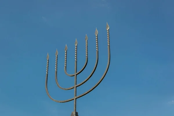 The menorah is a symbol of Judaism, the national-religious sign of Israel. Monument to the victims of the Holocaust in the village of Bogdanovka. Ukraine.