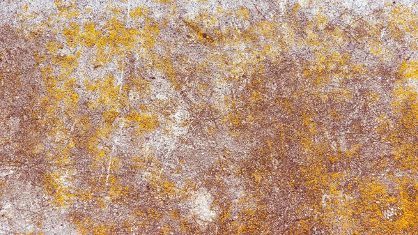 Vintage concrete background - weathered concrete surface with scratches and cracks in brown tone with remnants of light paint