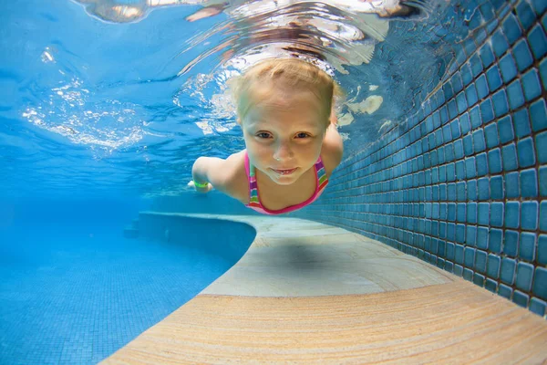子供の学習スイミングの面白い肖像画は 楽しい青いプールでダイビング スプラッシュで水中で深くジャンプします 健康的な家族生活 子供たちのウォータースポーツ活動 両親との水泳レッスン — ストック写真