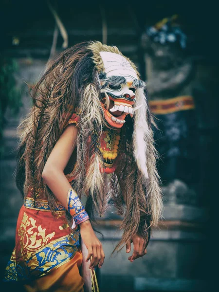 Dancer in demon Rangda traditional mask - evil spirit of Bali isalnd. Temple ritual dance at ceremony before Balinese silence day Nyepi. Religious festivals, art, ethnic culture of Indonesian people.