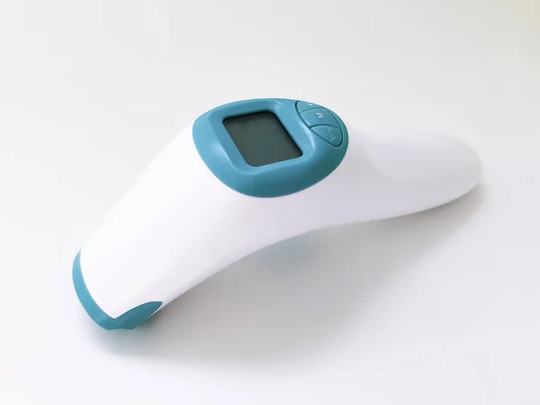 White electronic non-contact thermometer for measuring body temperature in children and adults on a white background. Safe, modern medical devices