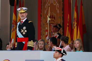 Madrid, Spain- October 12, 2019:Princess Leonor tells her father the King of Spain, Felipe VI, the parade they are witnessing on Armed Forces Day in Madrid