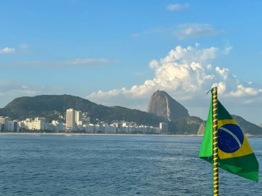 The Brazilian flag, with The Sugarloaf Mountain in the background. Rio De Janeiro, Brazil. March 16.2022.