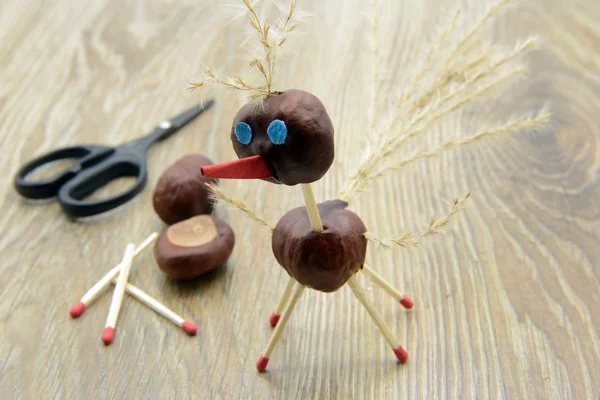 tinker creative chestnut bird figures in autumn. could be a stork or ostriches
