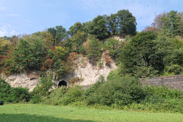 rail road tunnel next to trass caves at Brohltal valley at Eifel region in Germany. mining area of volcanic rock in roman times.
