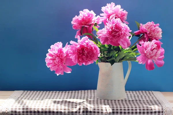 粉红牡丹 蓝色背景的水罐中的花园花花束 — 图库照片