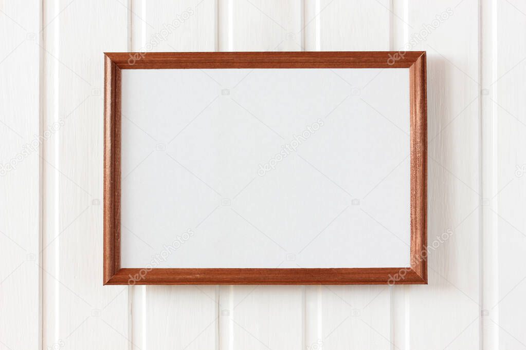 empty wooden frame hanging on a white wall from boards. mockup, scene creator.