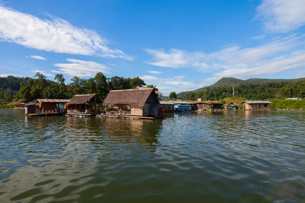 Floating house village on water surface under clear sky located at east of thailand