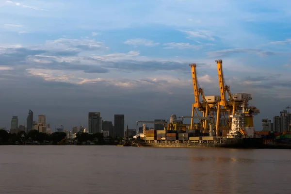 Photo of shipping of maritime transportation are under arrange big container loading in the big boat under big yellow crane at port authority of Thailand