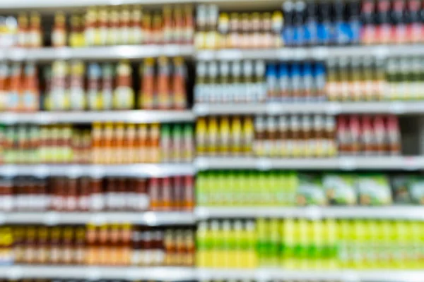 Blur image of shelf with consumer product shop in supermarket