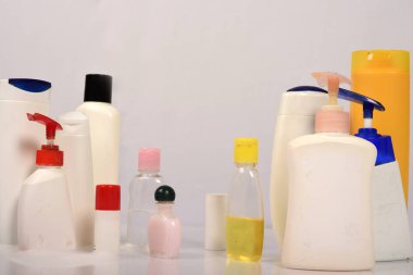 Beyaz arka plan üzerinde birçok beyaz plastik şişe. 