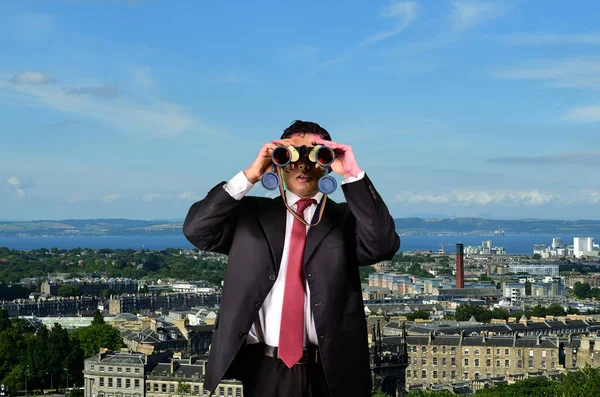 Business Man is spying with Binoculars on Competitors