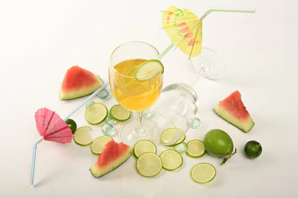 Watermelon, pieces of lemon on white background for preparing cool drinks.