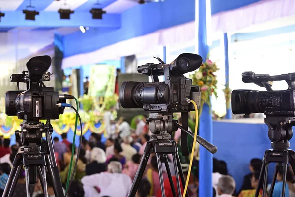 Video journalist capturing moving picture by camcorder in a event