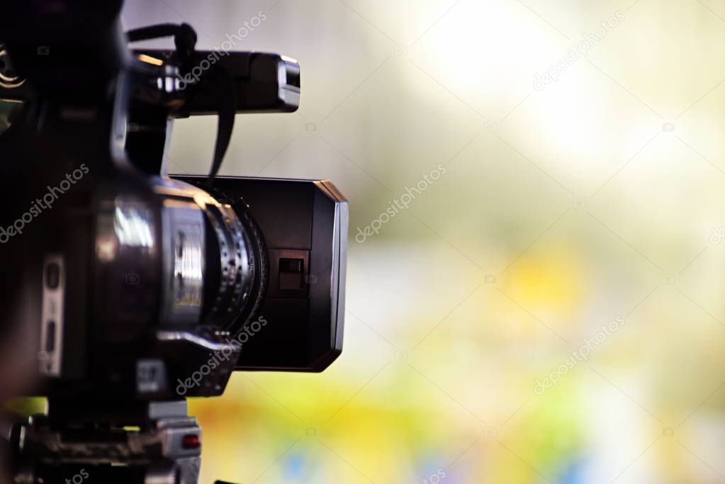 Video journalist capturing moving picture by camcorder in a event