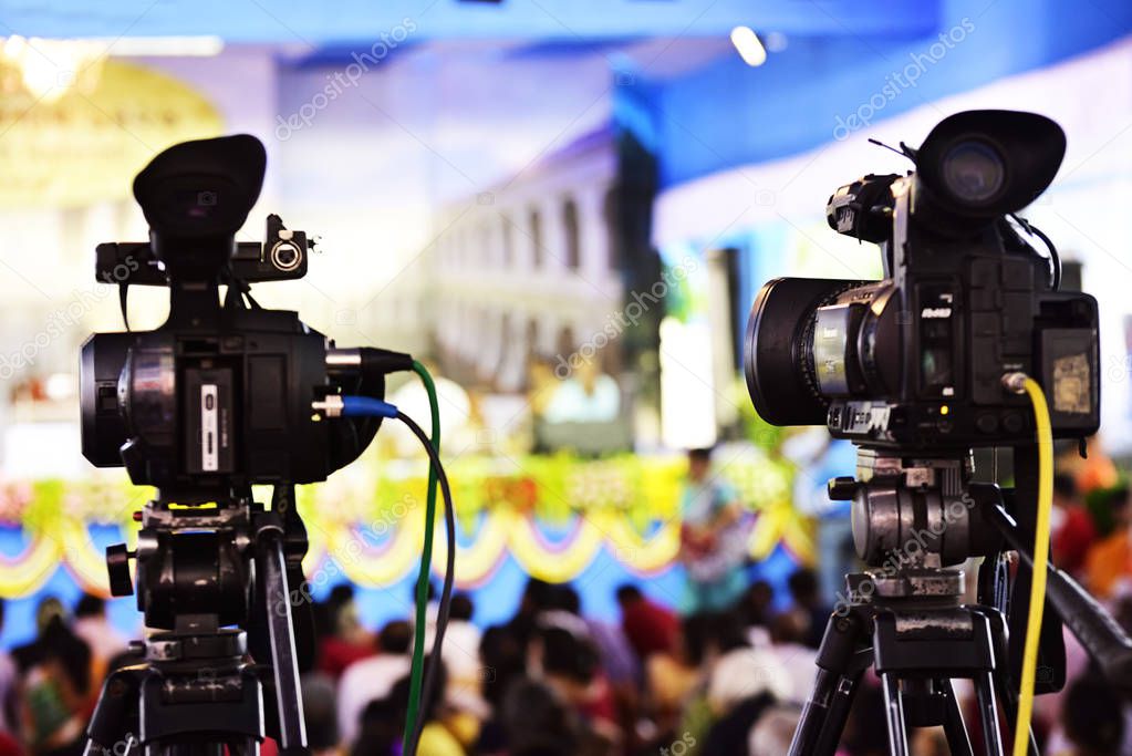 Video journalist capturing moving picture by camcorder in a event