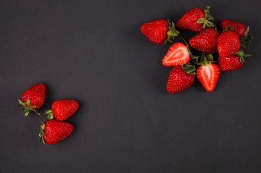 Siyah arka plan üzerinde olgunlaşmış taze çilek. Meyve yakın çekim