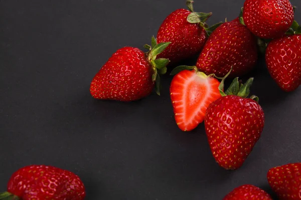 Ripe fresh strawberry on black background. Fruits close up