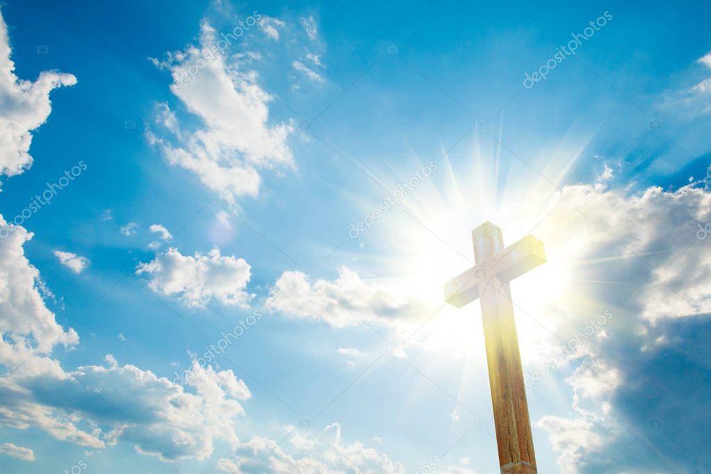 Wood cross on blue sky. Religious concept