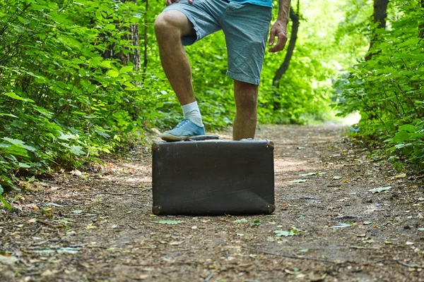 People with suitcase outdoor. Travel concept. Wood road