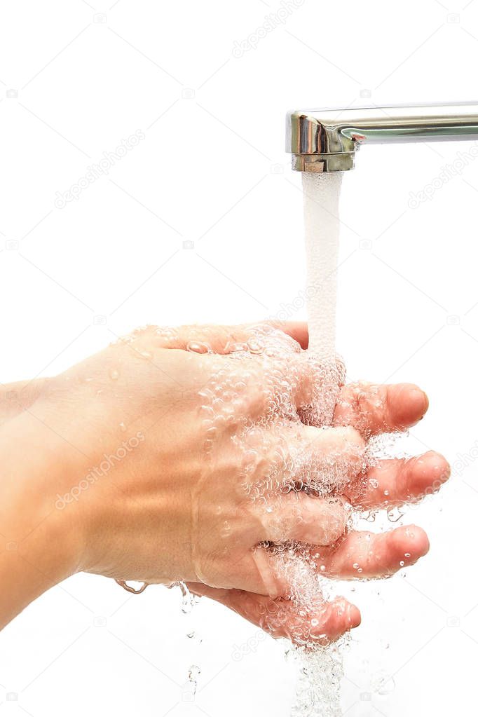 Washing hands under flowing tap water, isolated on the white background