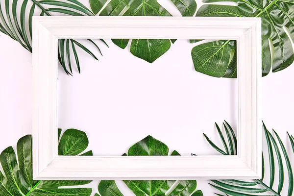 Creative layout made of tropical leaves with vintage frame. — Stock Photo, Image