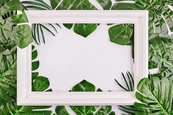 Creative layout made of tropical leaves with vintage frame. — Stock Photo, Image