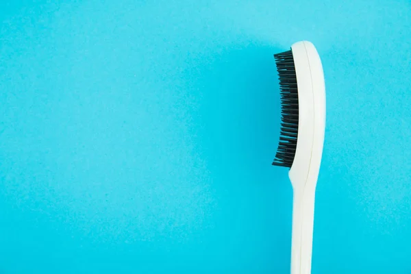 Hairbrush on blue background — Stock Photo, Image