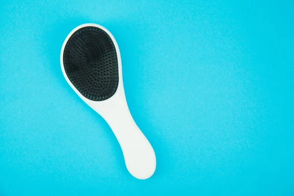 Hairbrush on blue background — Stock Photo, Image