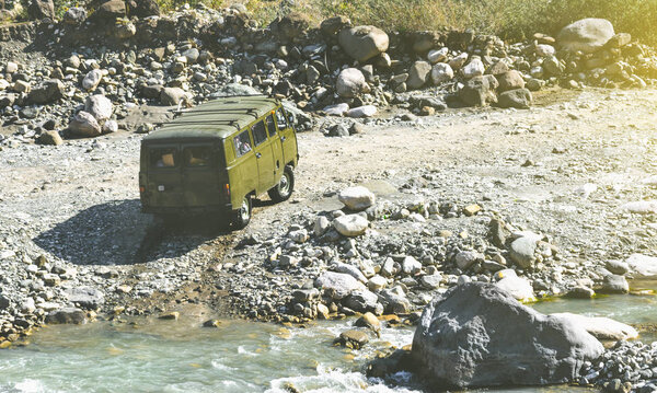 Off-road van moving on the dried river