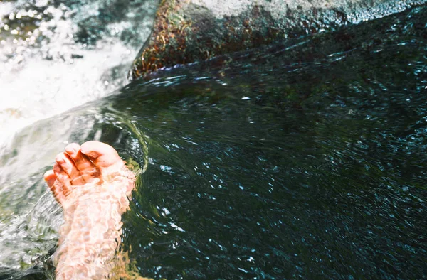 Männer Füße in einem Wasserstrom zwischen dem Fluss — Stockfoto