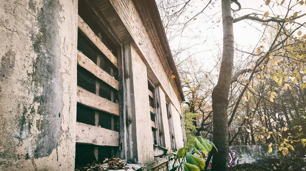 Abandoned building with bars in a forest park